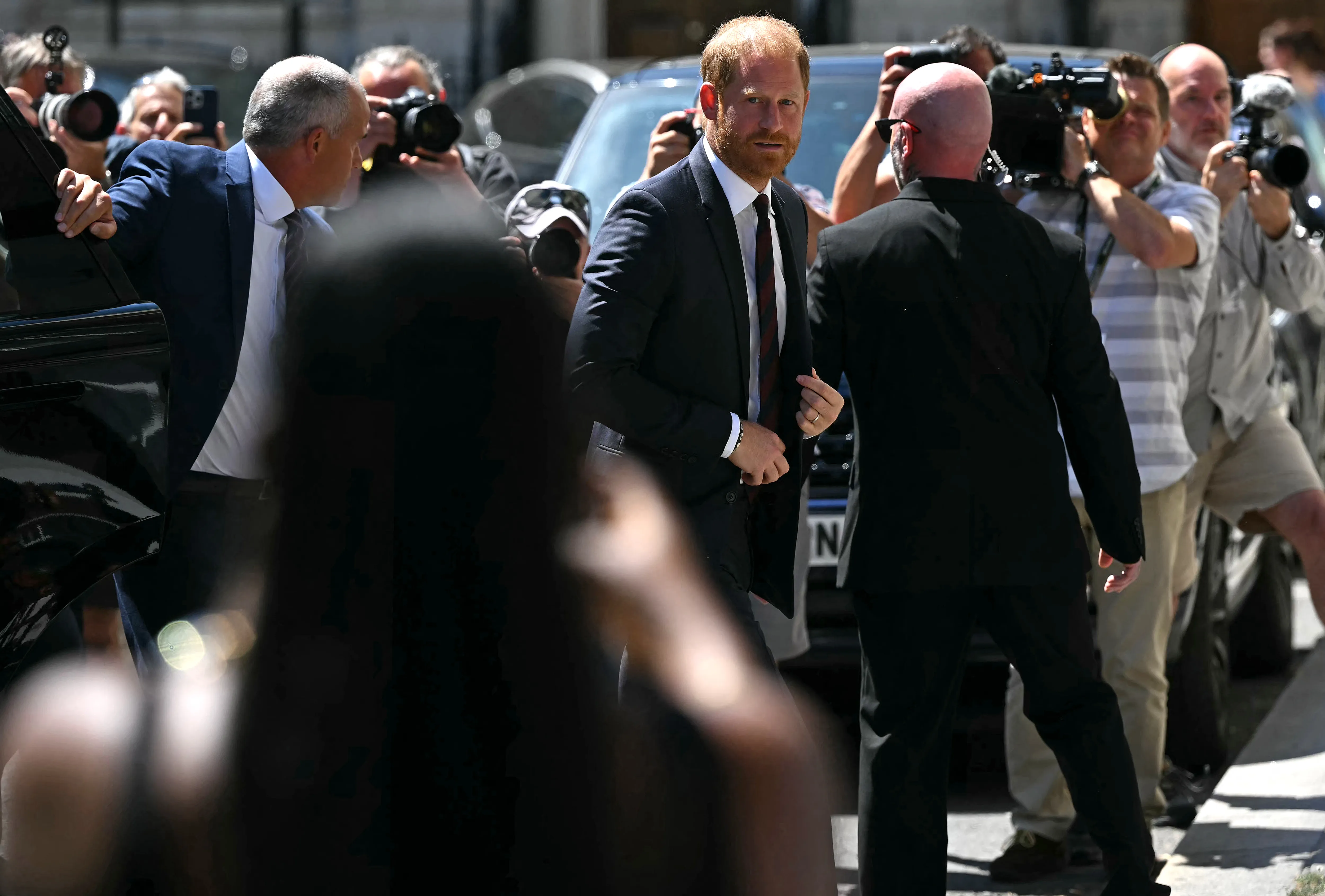 Prince Harry, Duke of Sussex, walking past photographers.