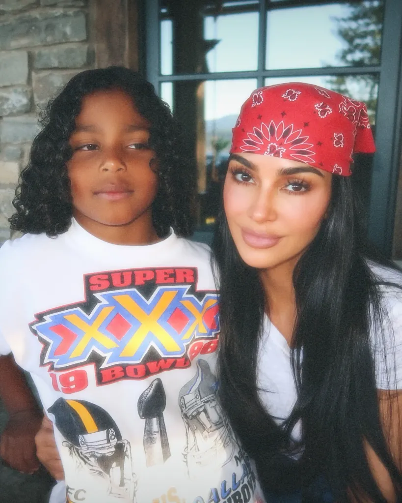 Kim Kardashian and a child posing for a photo.