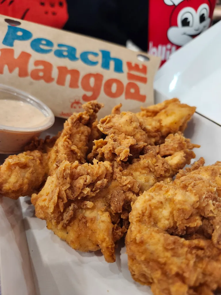 Jollibee's chicken tenders with dipping sauce and a 