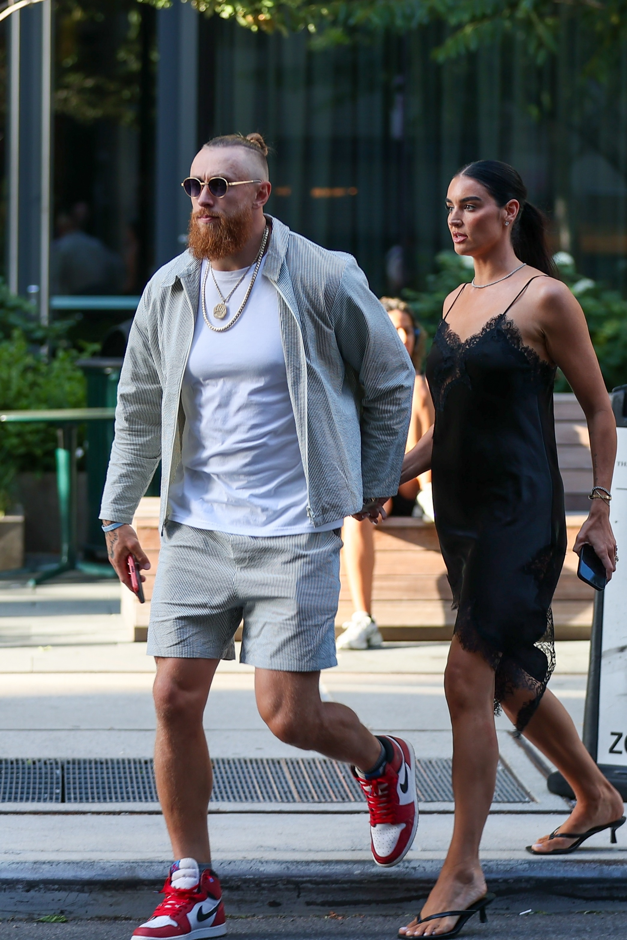 George Kittle and Claire Kittle walking together.