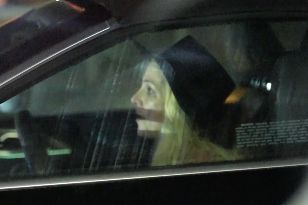 Britney Spears driving a car at night.