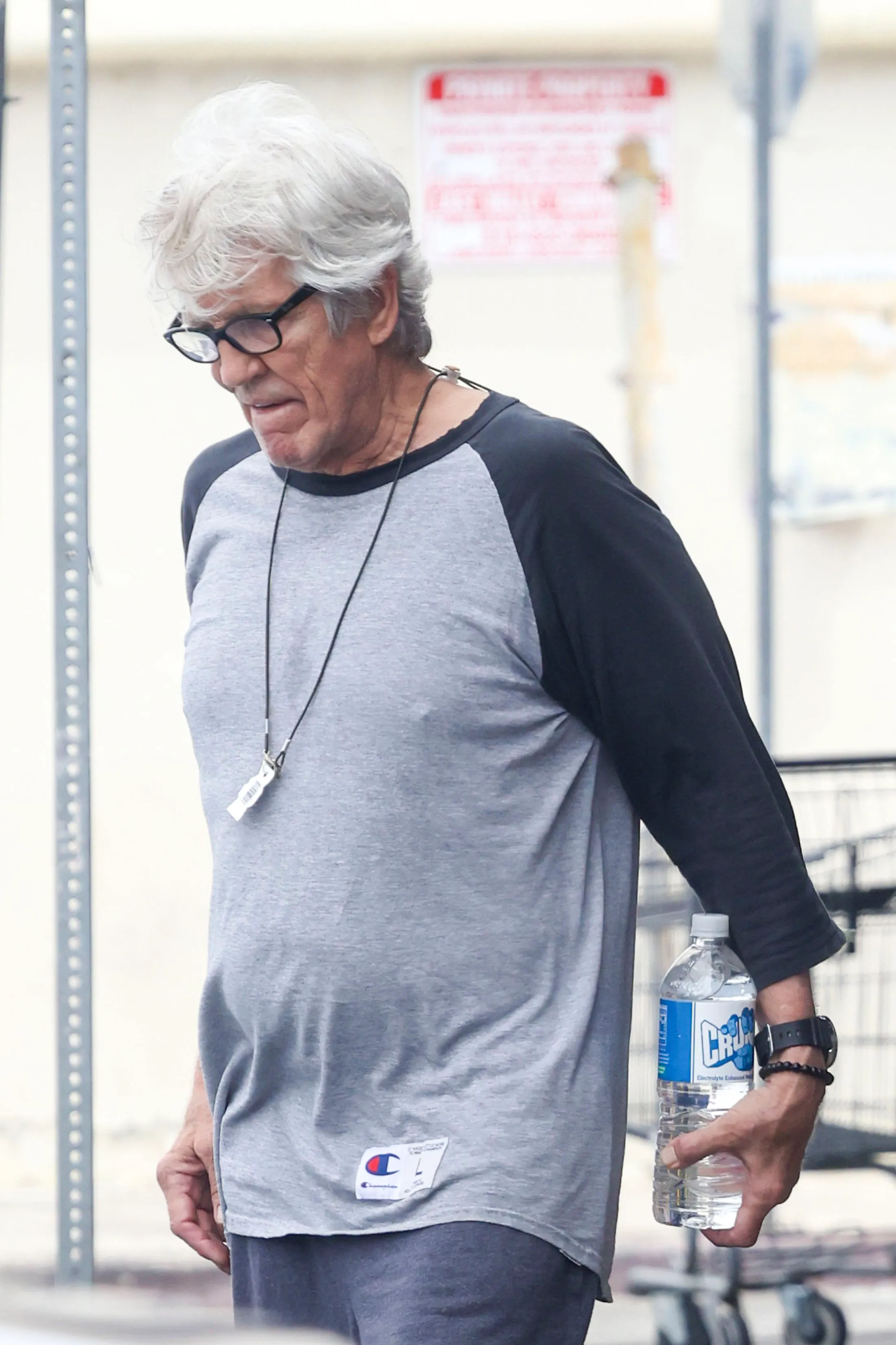 Eric Roberts leaving Crunch Gym carrying a water bottle.