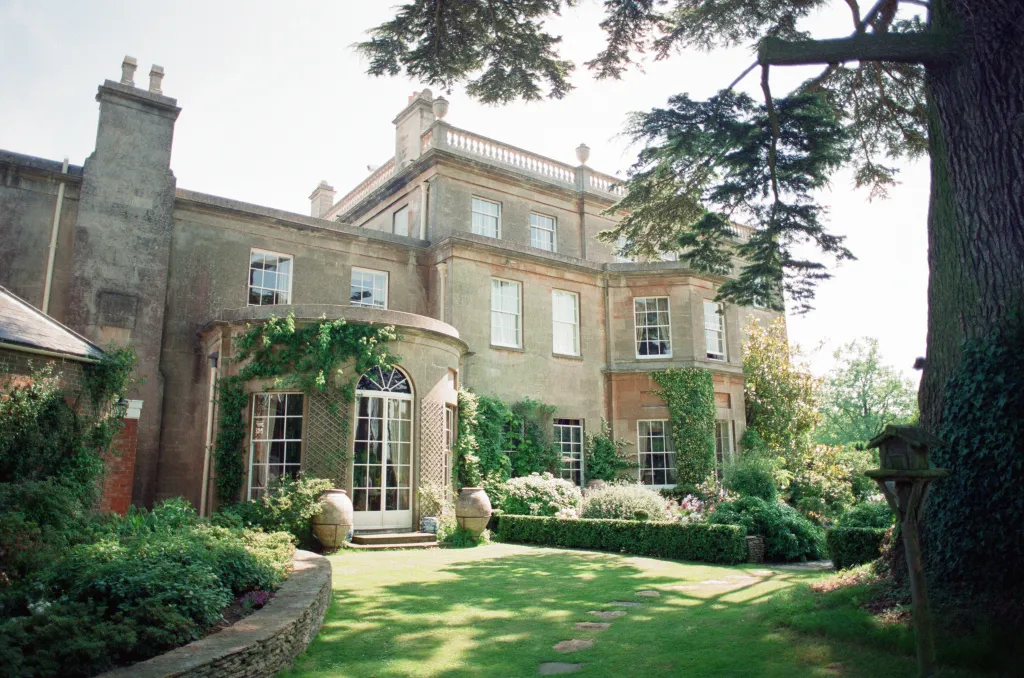 Highgrove House, Prince Charles's private residence, with green gardens in the foreground.