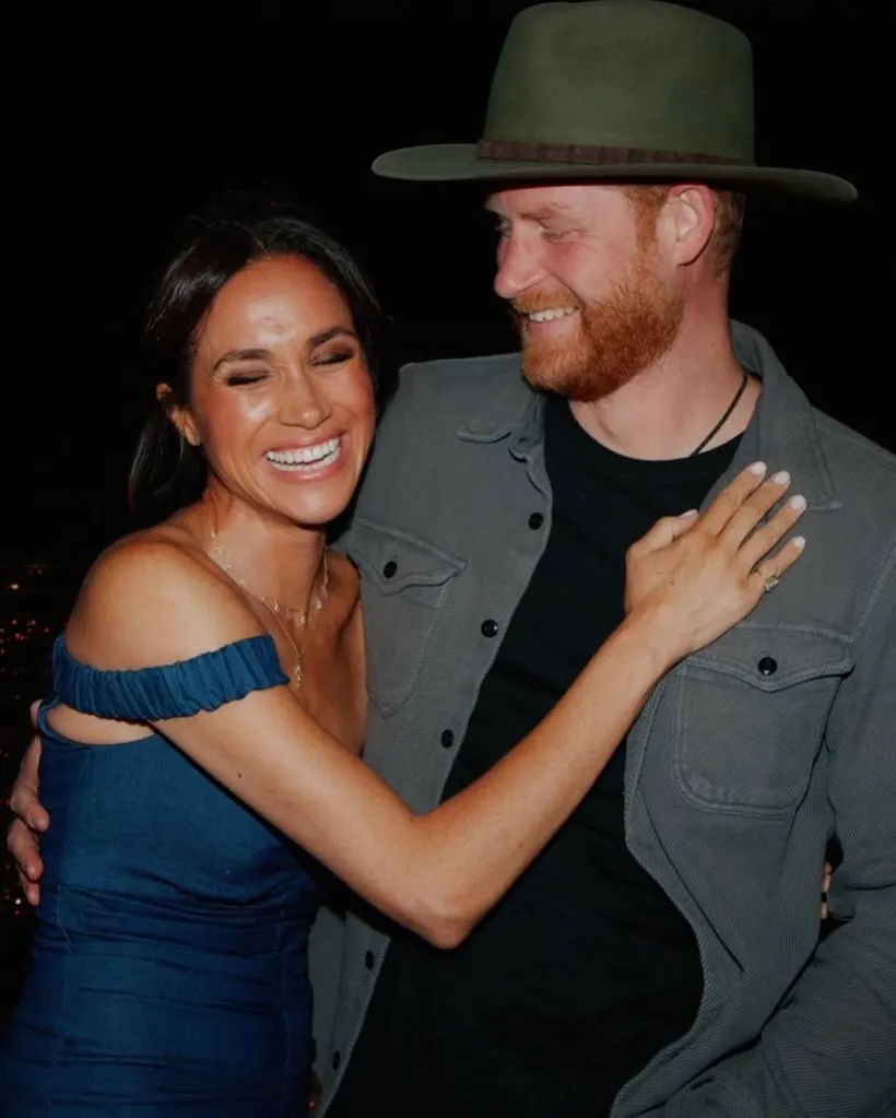 Meghan Markle and Prince Harry embracing and laughing.