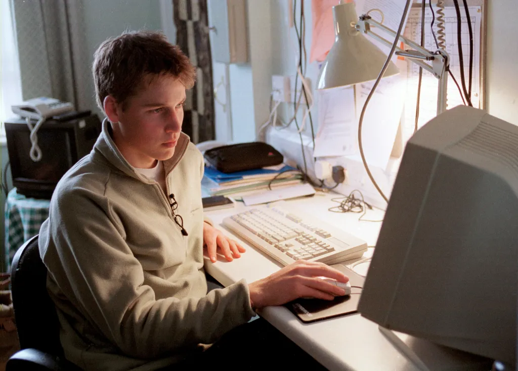 Prince William using a computer at his desk at Eton College.
