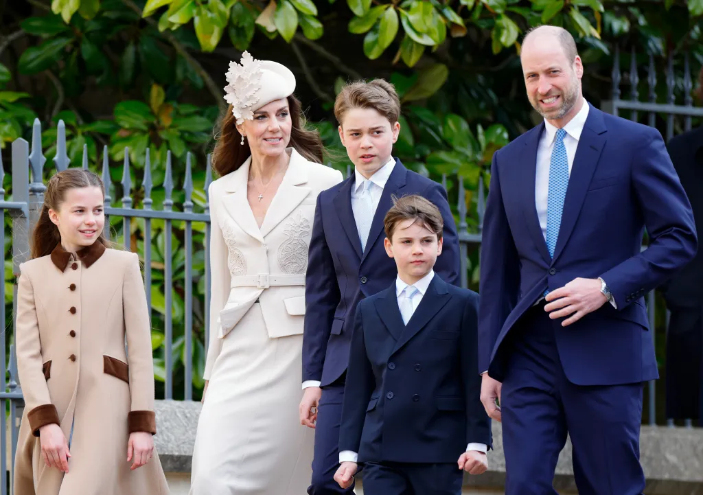 Prince William holding his son Prince George, who is hugging him.