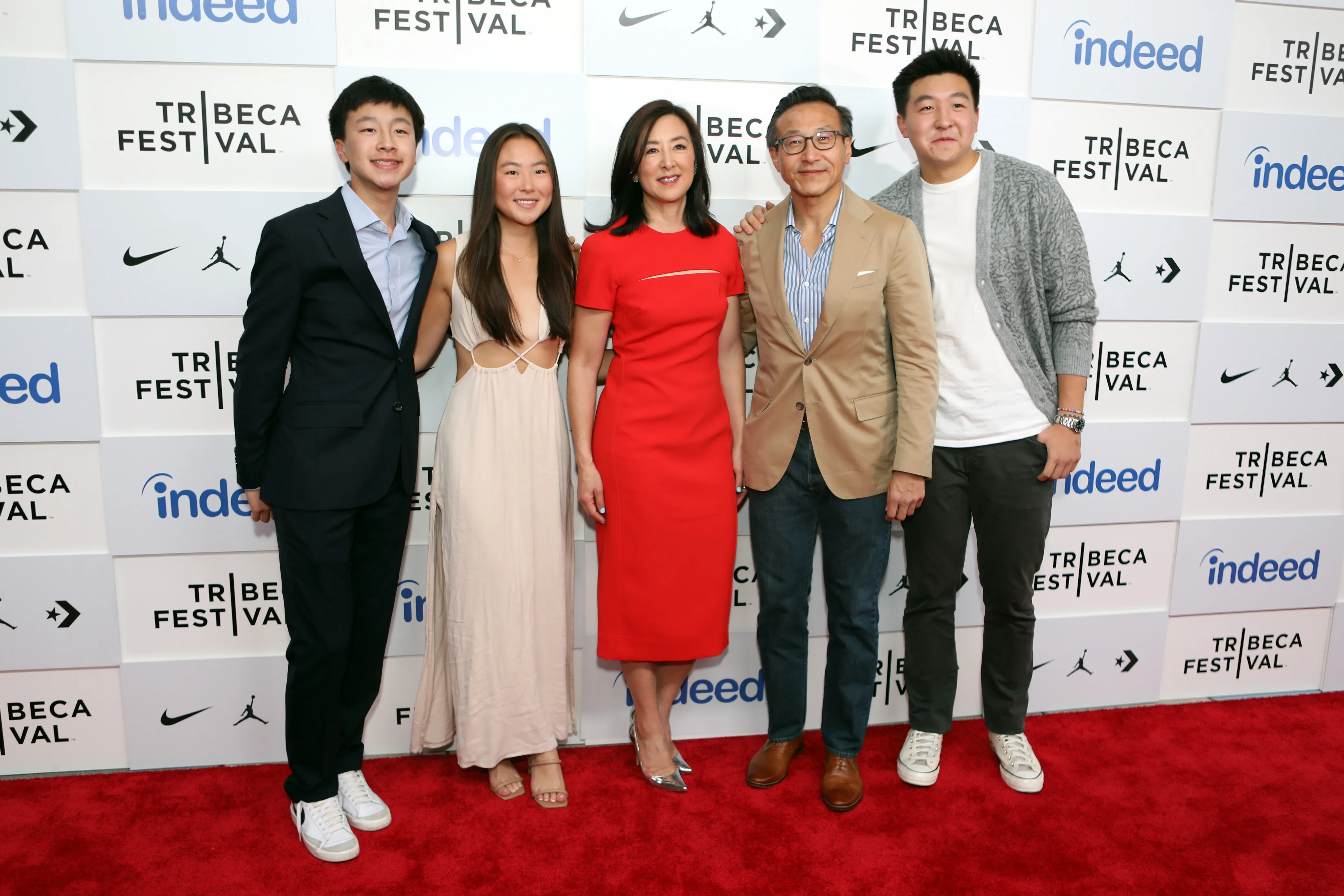 Clara Wu Tsai, Joe Tsai, and their children Jacob, Alex, and Dash Tsai posing on a red carpet.