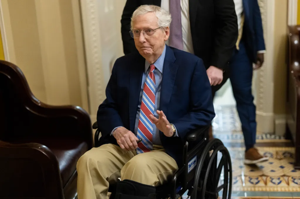 Senator Mitch McConnell in a wheelchair departing a Senate Republican caucus luncheon.