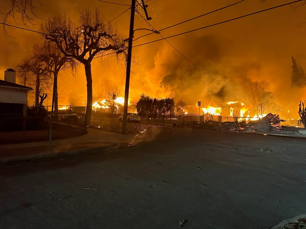 Houses ablaze with orange flames during the Easton Fire.
