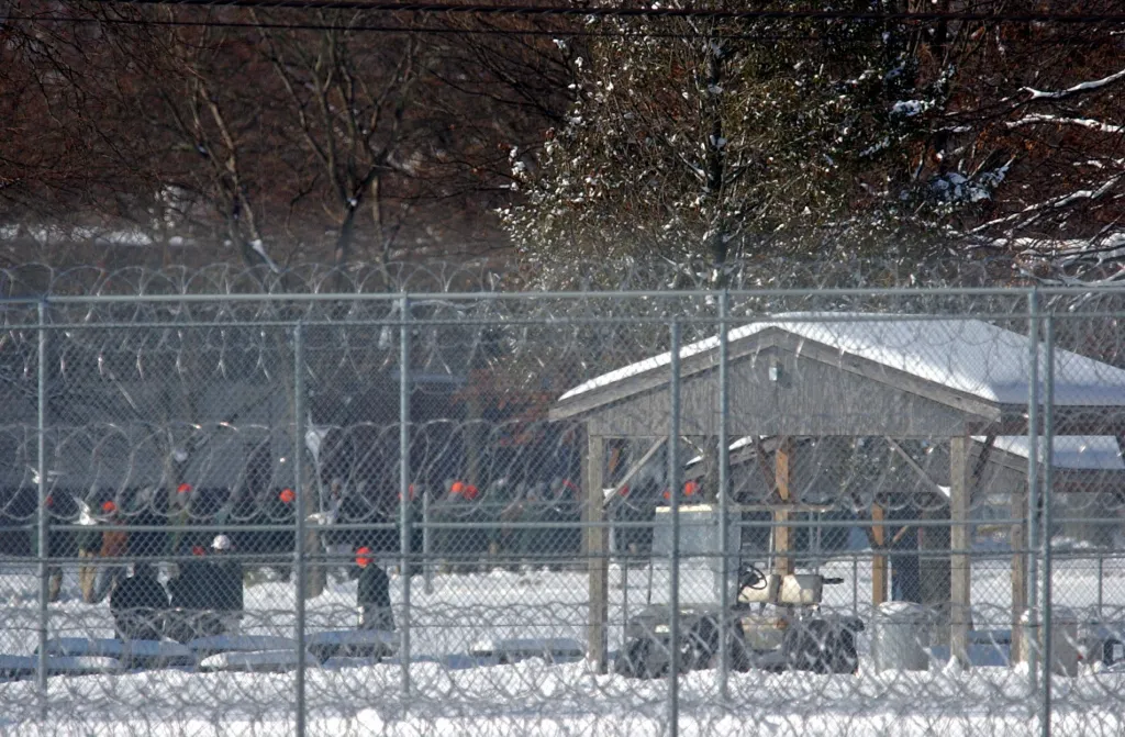 Razor wire fence around a snow-covered courtyard at FCI Fort Dix.