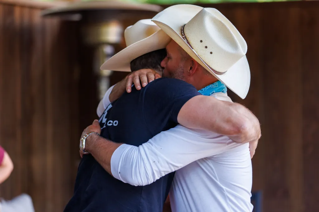Steven McBee Jr. and Steve McBee hugging.
