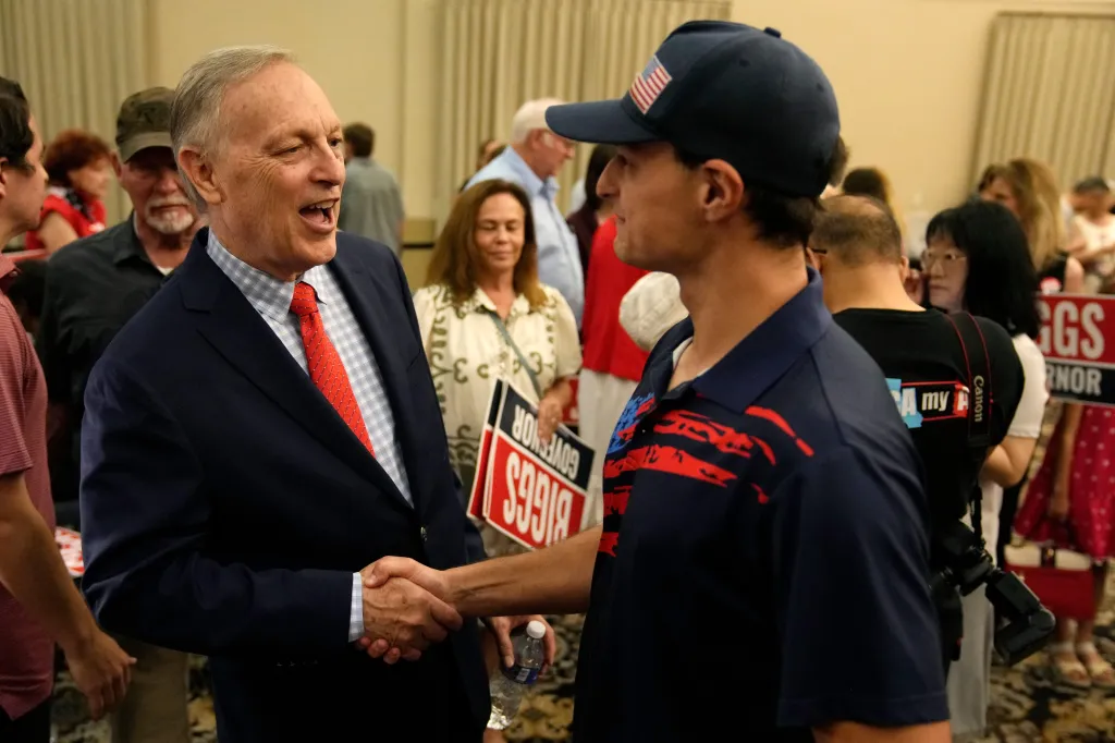 Rep. Andy Biggs shaking hands with a supporter at a campaign event.
