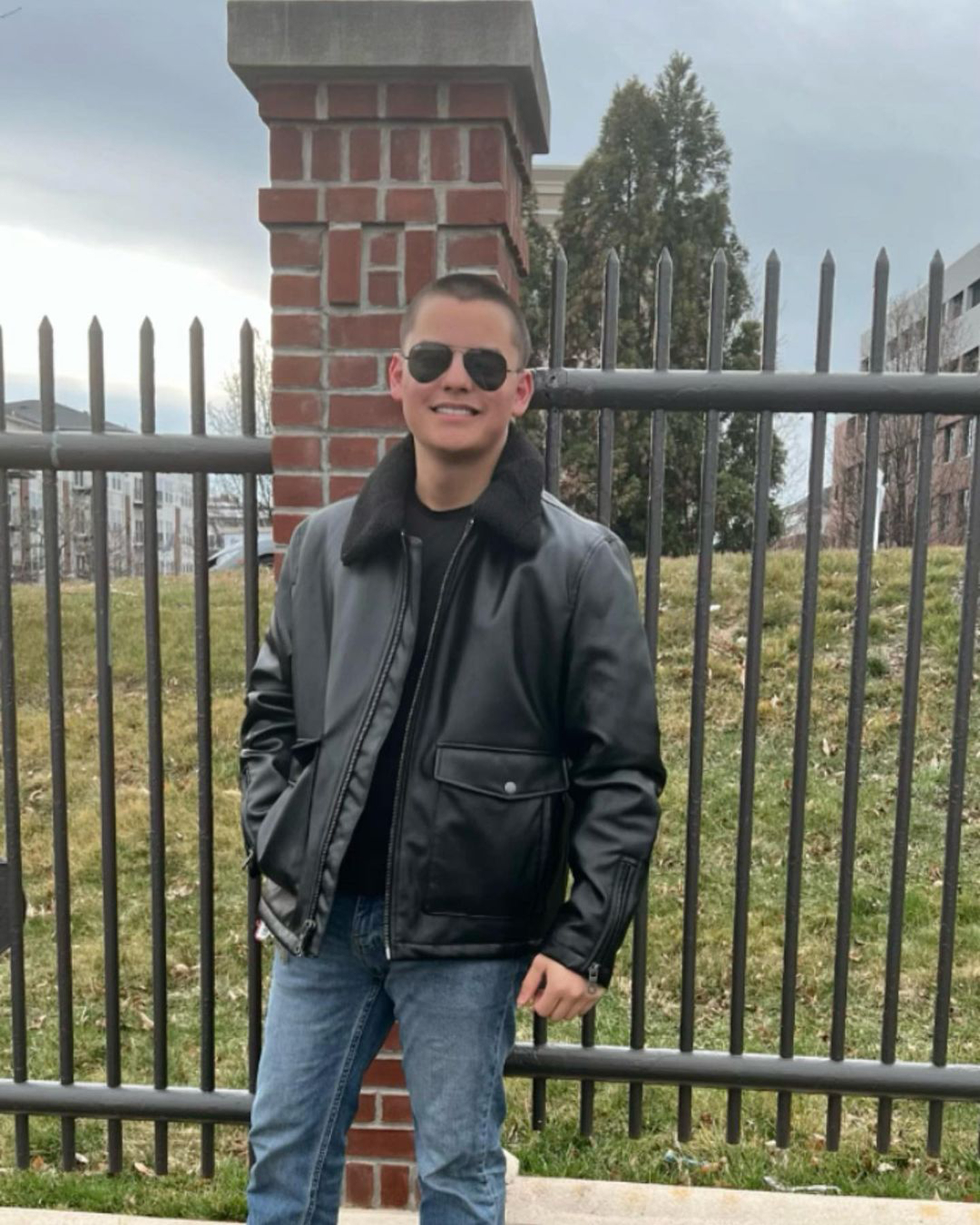 Collin Gosselin smiling in a black leather jacket and sunglasses.
