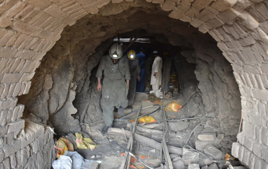 Rescue workers and residents inside a collapsed coal mine.