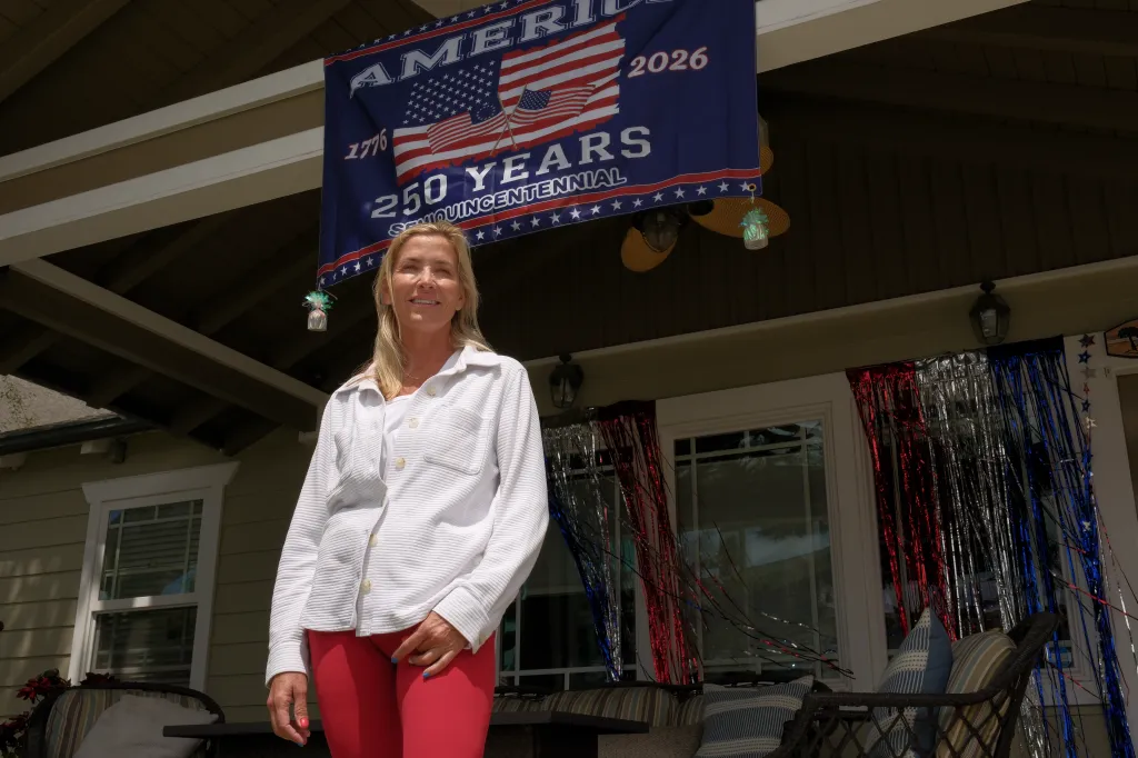 Cindy Guinasso, a 56-year-old Huntington Beach homeowner, stands in front of her decorated home.