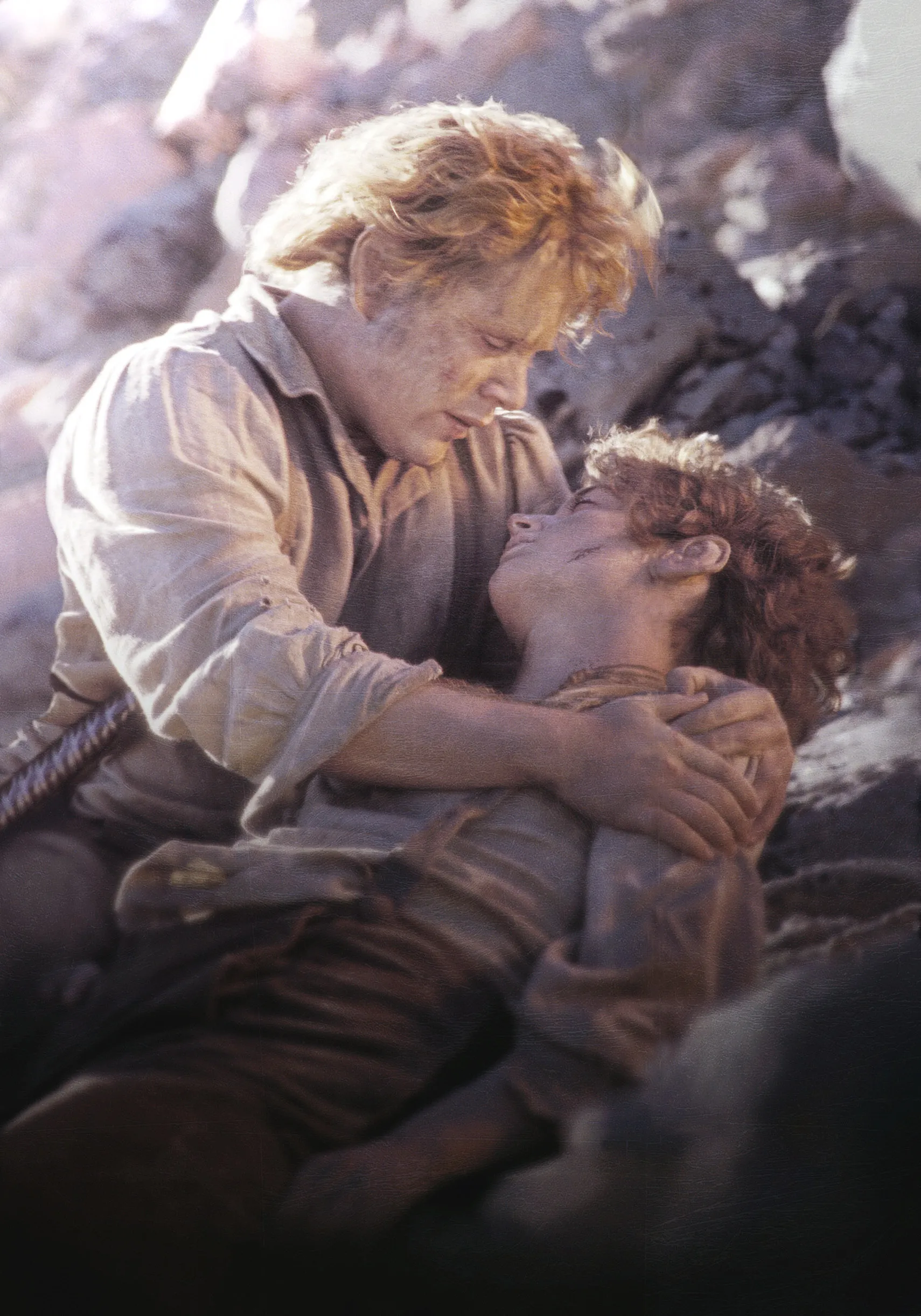 Sean Astin cradles an injured Elijah Wood, who lies unconscious in his arms.