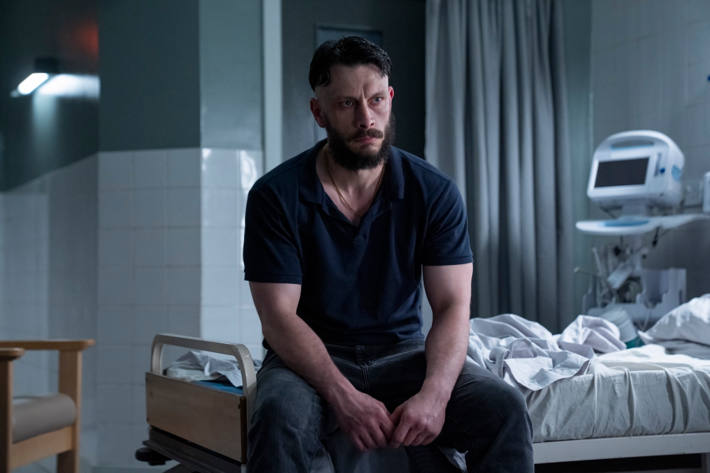 Richard Gadd as Donny Dunn in "Baby Reindeer" sitting on a hospital bed.