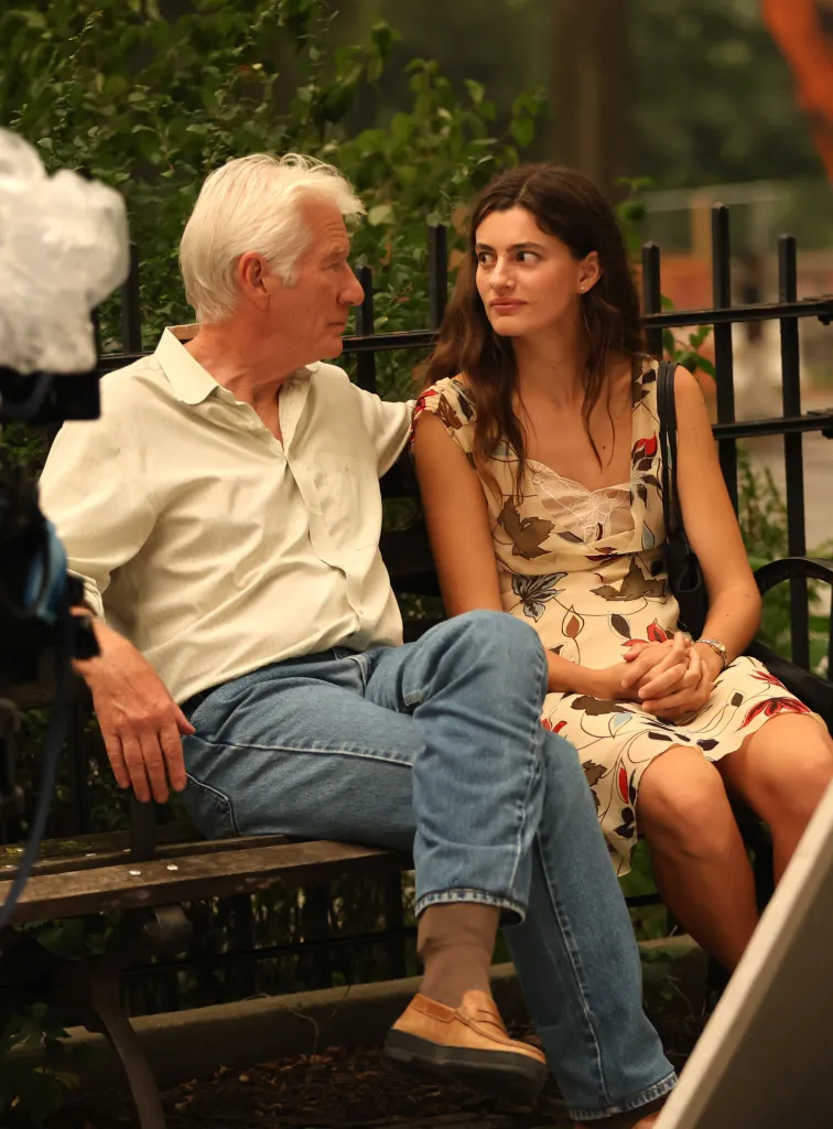 Richard Gere and Diana Silvers sitting on a bench while filming "Asymmetry."