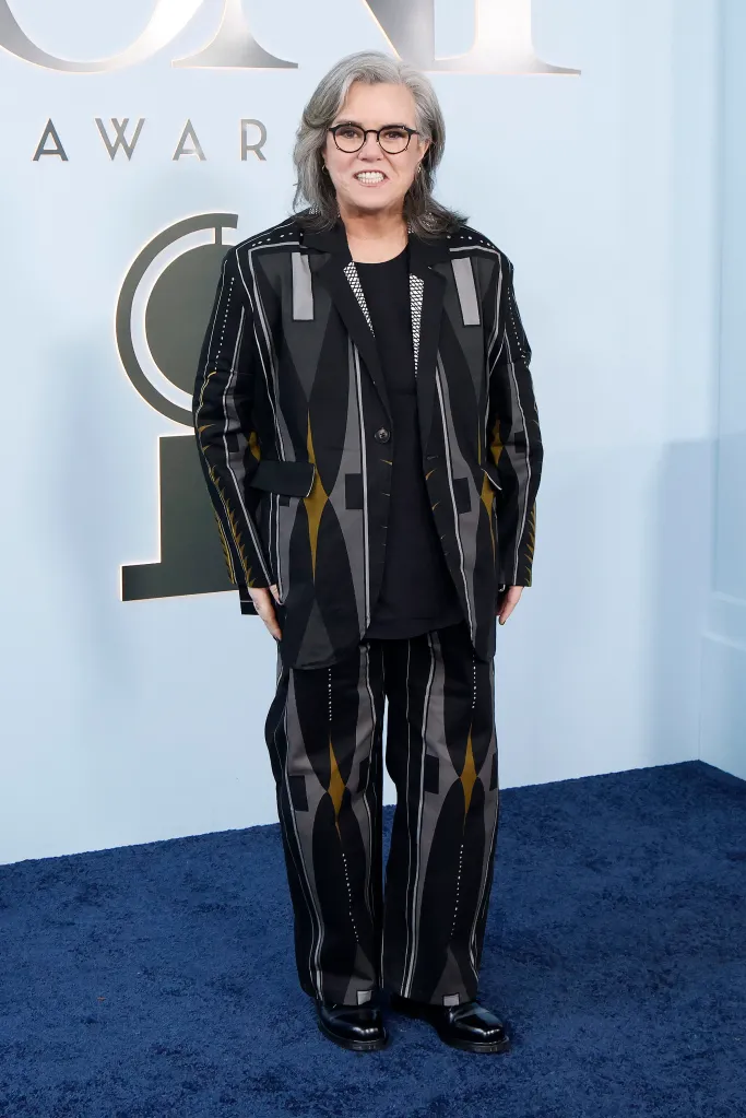 Rosie O'Donnell in a black, gray, and gold patterned suit.