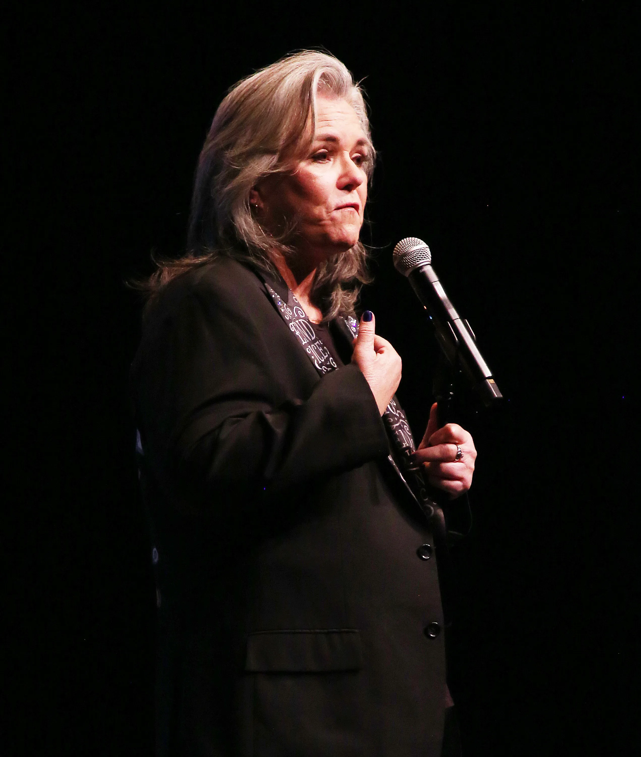 Rosie O'Donnell speaking into a microphone.