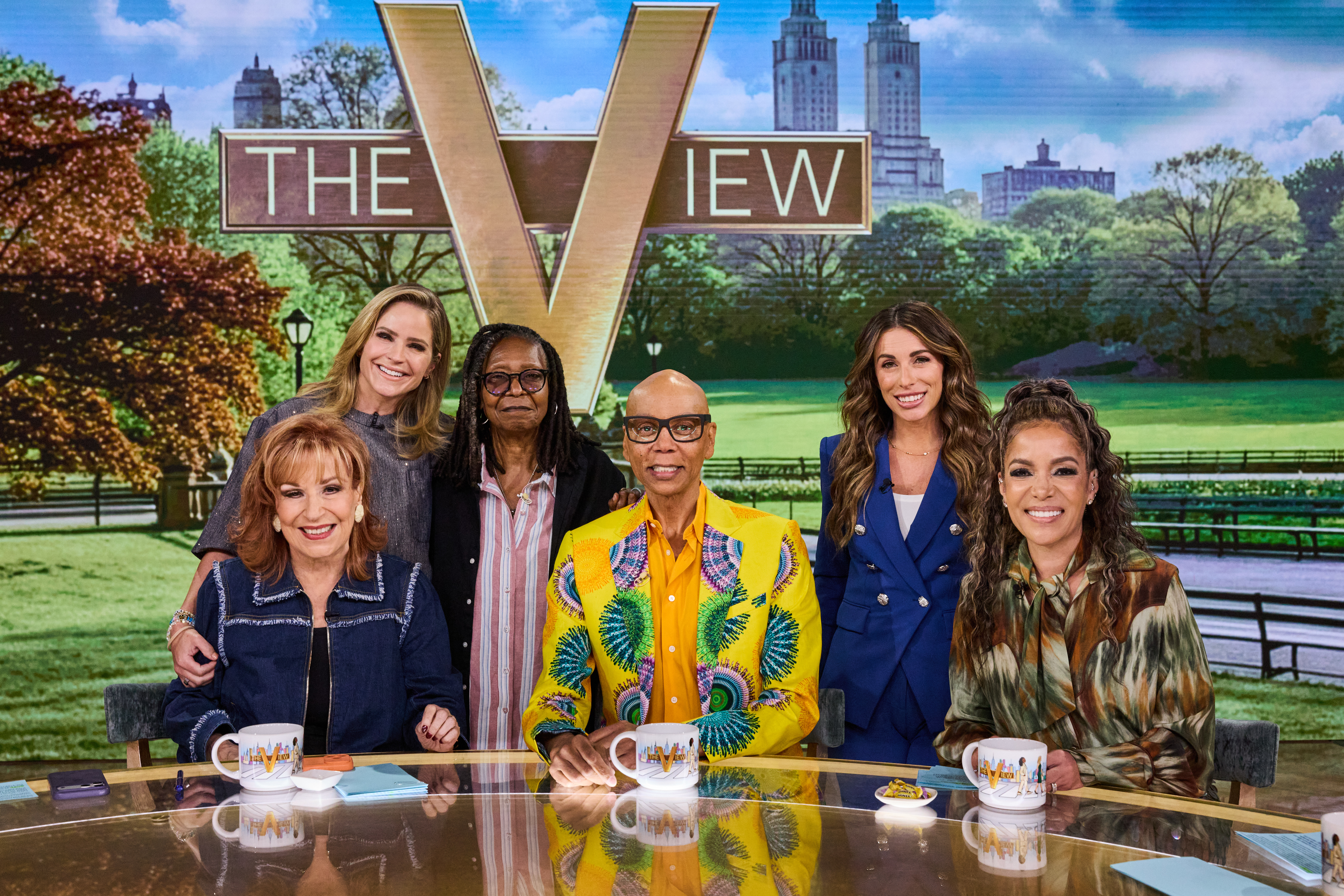 Joy Behar, Sara Haines, Whoopi Goldberg, RuPaul, Alyssa Farah, and Sunny Hostin sit at a table for "The View."
