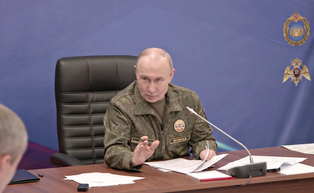 Vladimir Putin in military uniform at a Russian Forces command post.