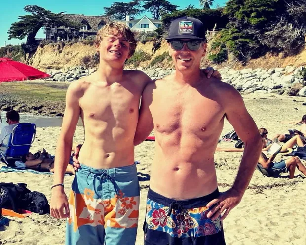 Ryder Williams and his father, Shane, standing on a beach.