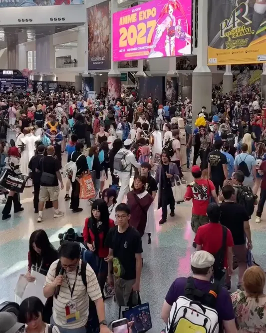 Large crowd of people, many in costumes, at the Anime Expo 2027 in the LA Convention Center.