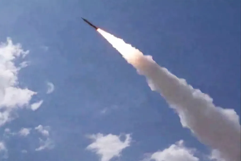 A missile launching into the sky, leaving a trail of smoke and fire.