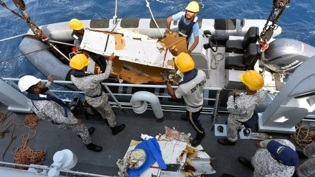 Pakistan Navy personnel recover wreckage from a missing cargo plane in the Arabian Sea.