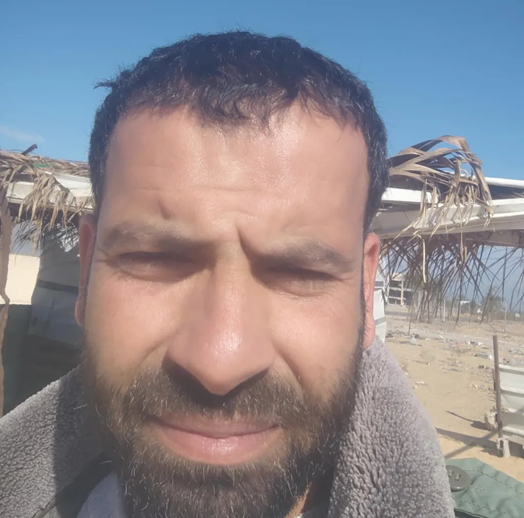 Salem Abu Amra, a man with a beard, looks directly into the camera.