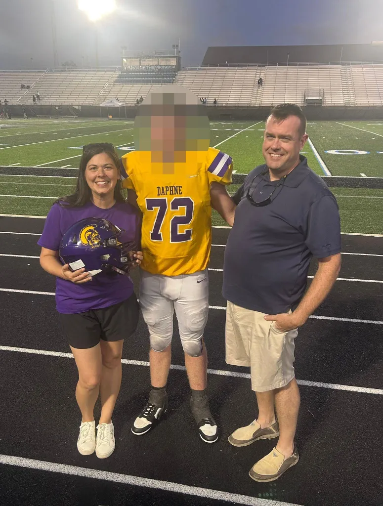 mom dad and son football photo