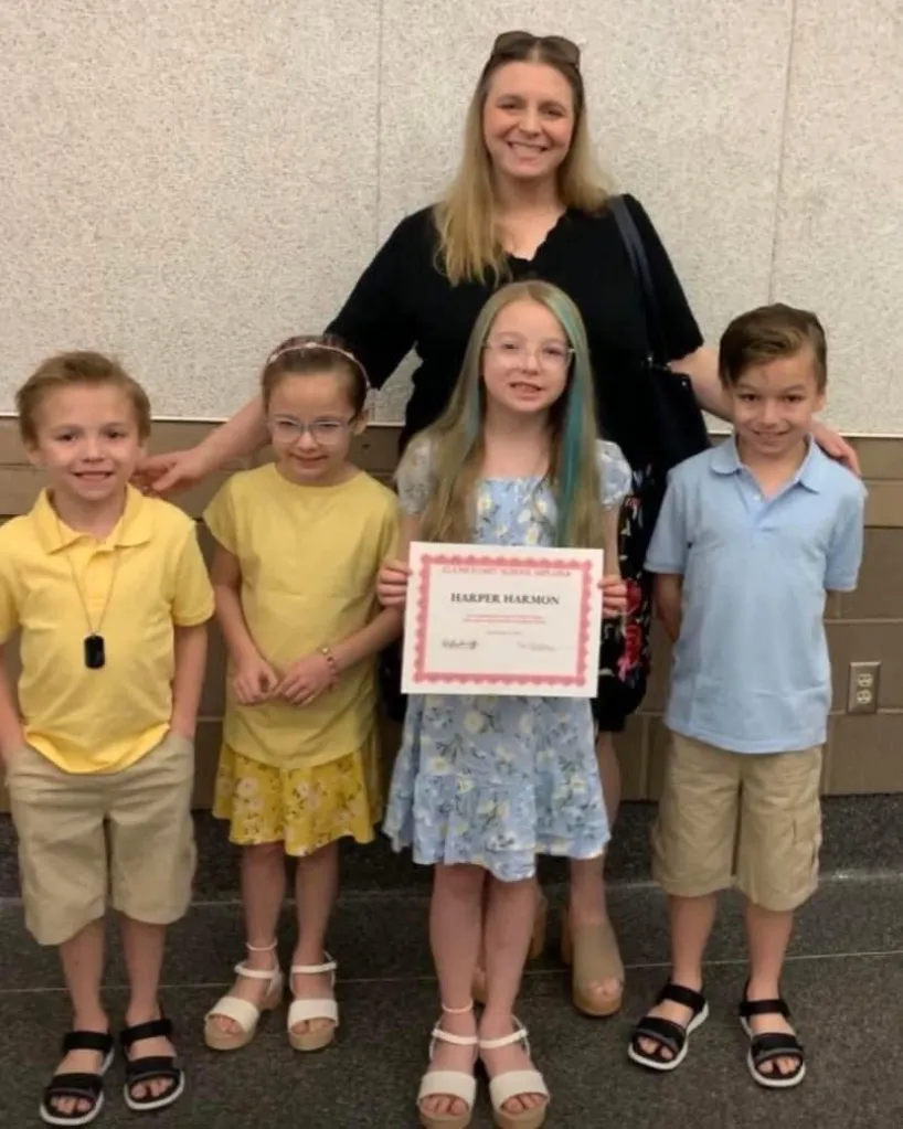Sarah Myers with her four children, including Harper Harmon holding a certificate.