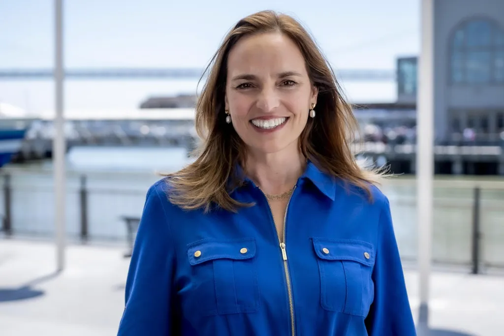 Elaine Forbes, Sausalito's City Manager, smiling in a blue collared dress.