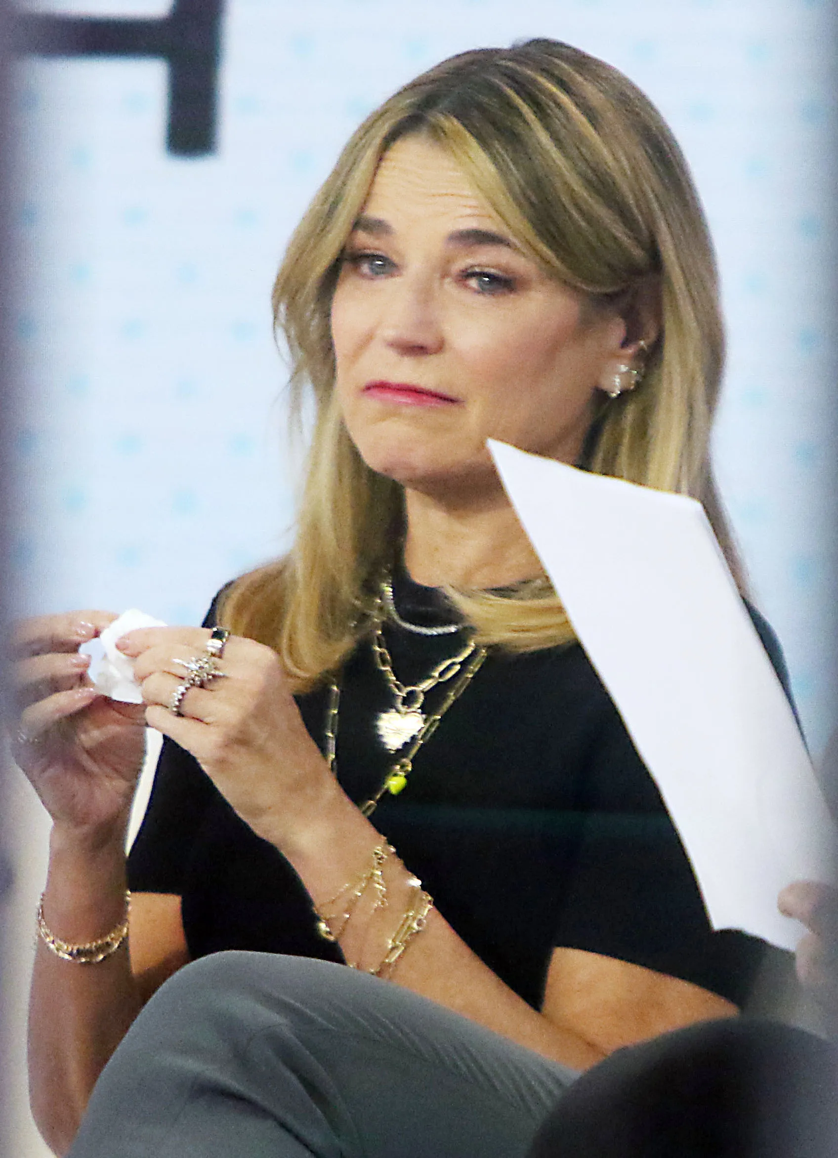 Savannah Guthrie on the Today Show, holding a tissue.