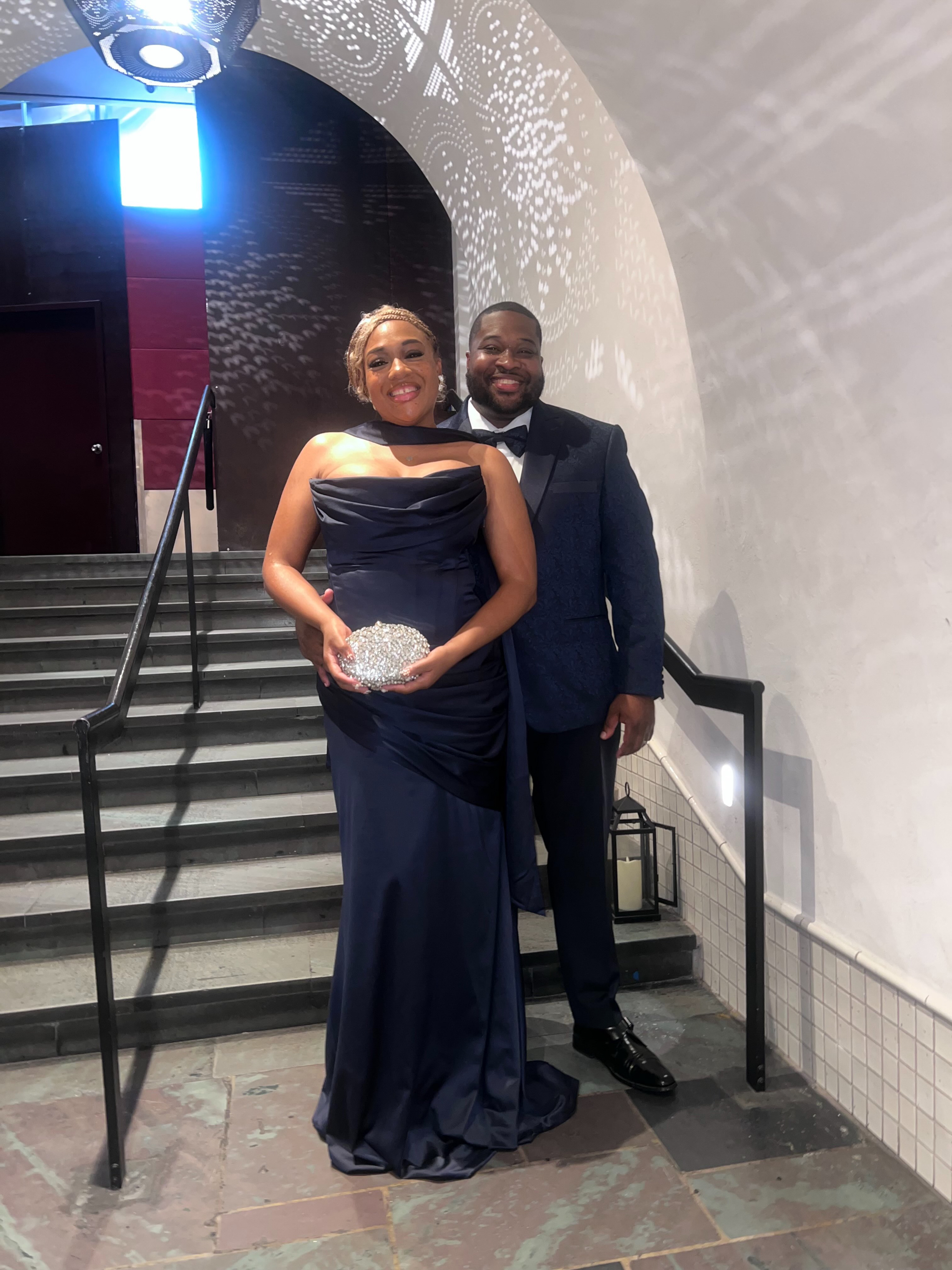 Shavonne Hall and her husband posing on a staircase.
