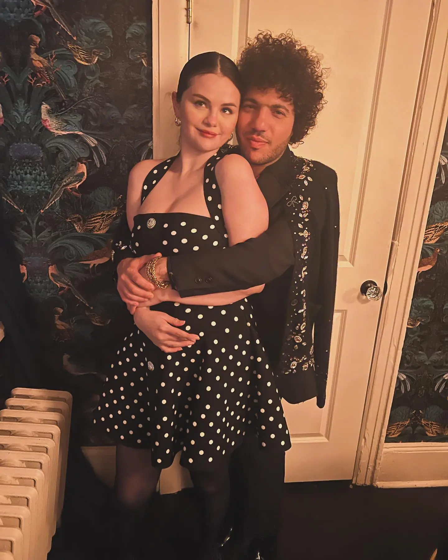 Selena Gomez and Benny Blanco pose with their arms around each other.