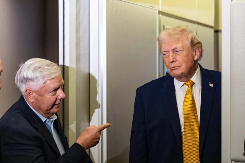 Sen. Lindsey Graham, R-S.C., left, gestures as President Donald Trump speaks with reporters while in flight on Air Force One, Jan. 4, 2026,