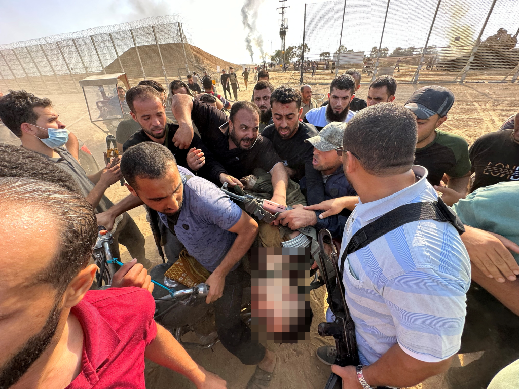 Palestinians carrying what they say is the body of an Israeli killed by Hamas gunmen.