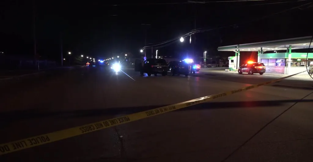 Crime scene with flashing police lights at night.