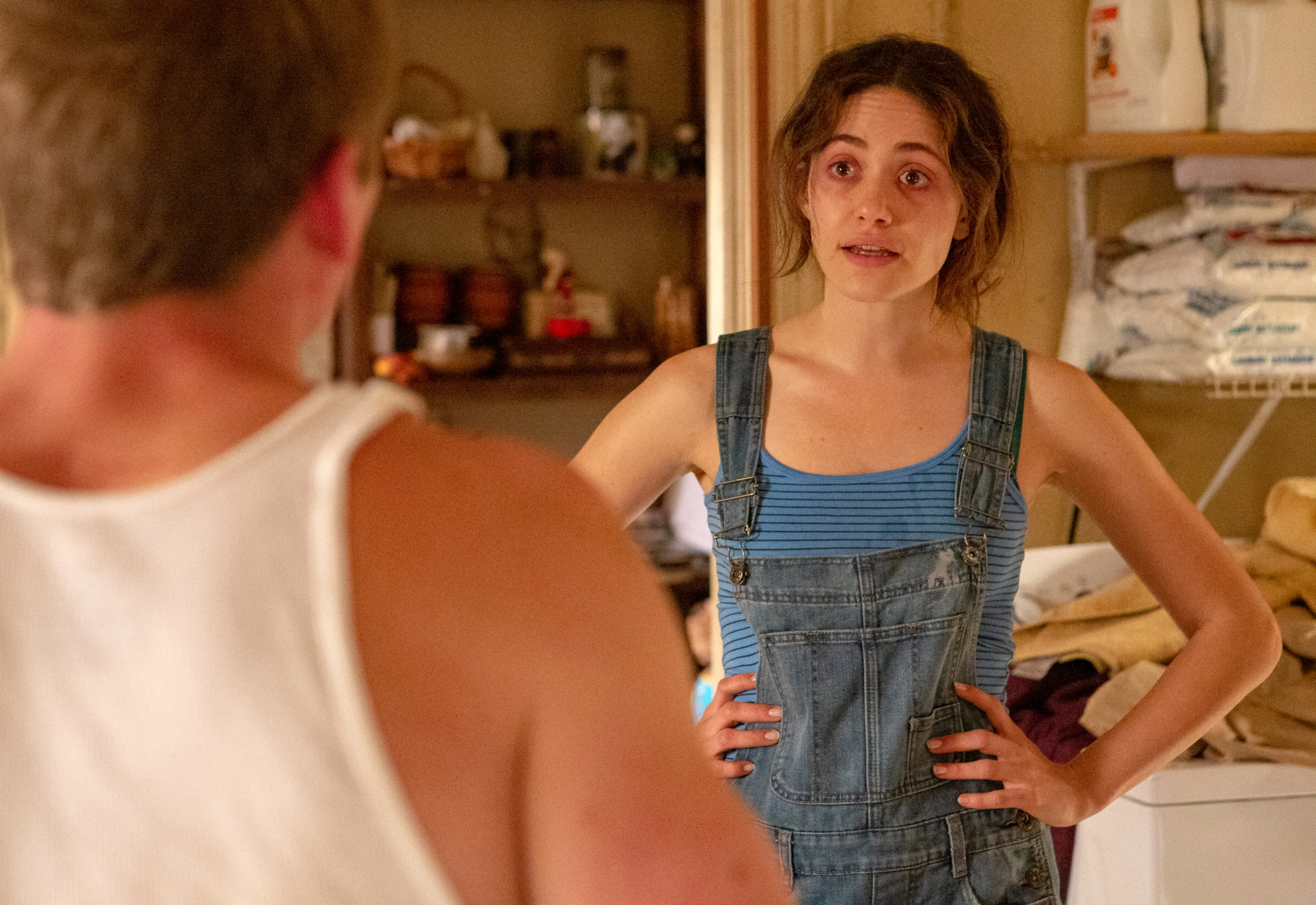 Emmy Rossum as Fiona Gallagher with red eyes and hands on hips, confronting someone.