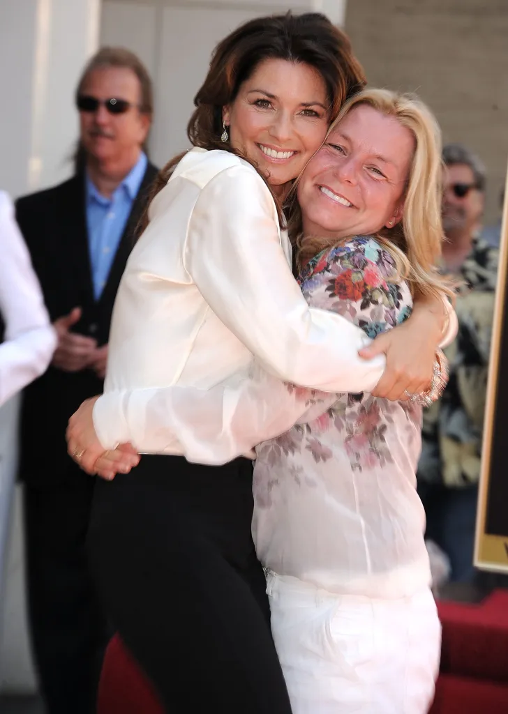 Shania Twain and her sister embrace at the Shania Twain Hollywood Walk Of Fame Induction Ceremony.