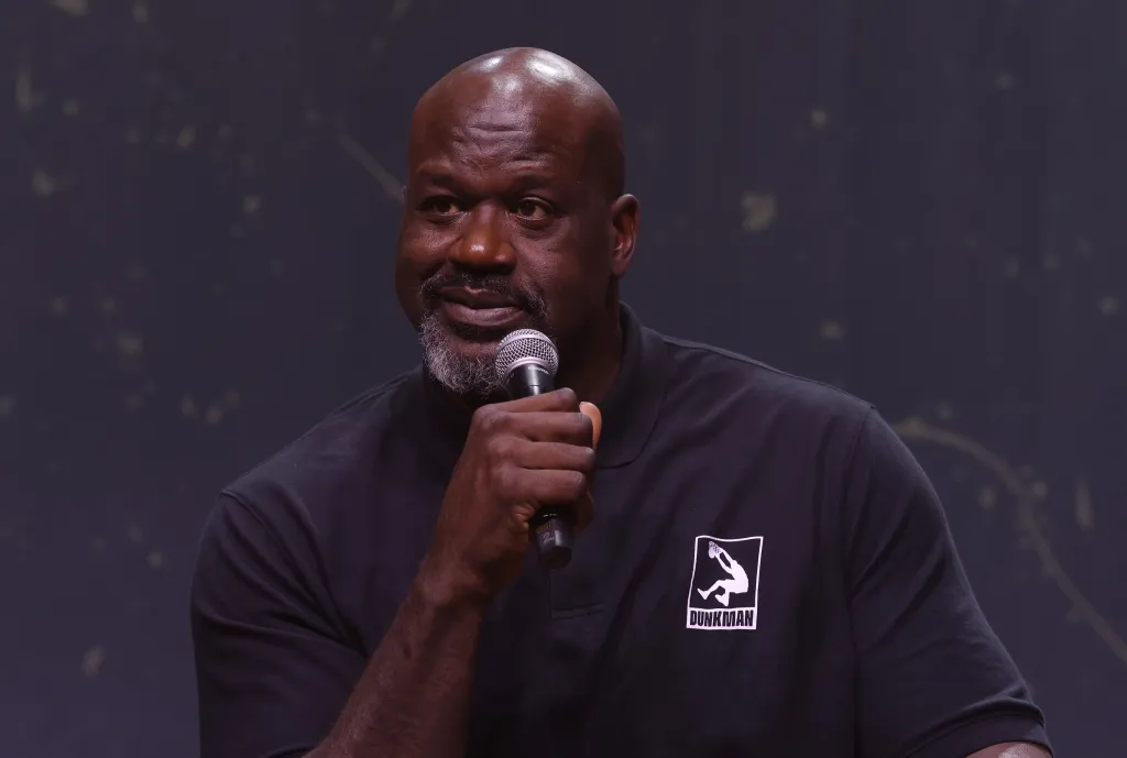 Shaquille O'Neal speaking into a microphone.