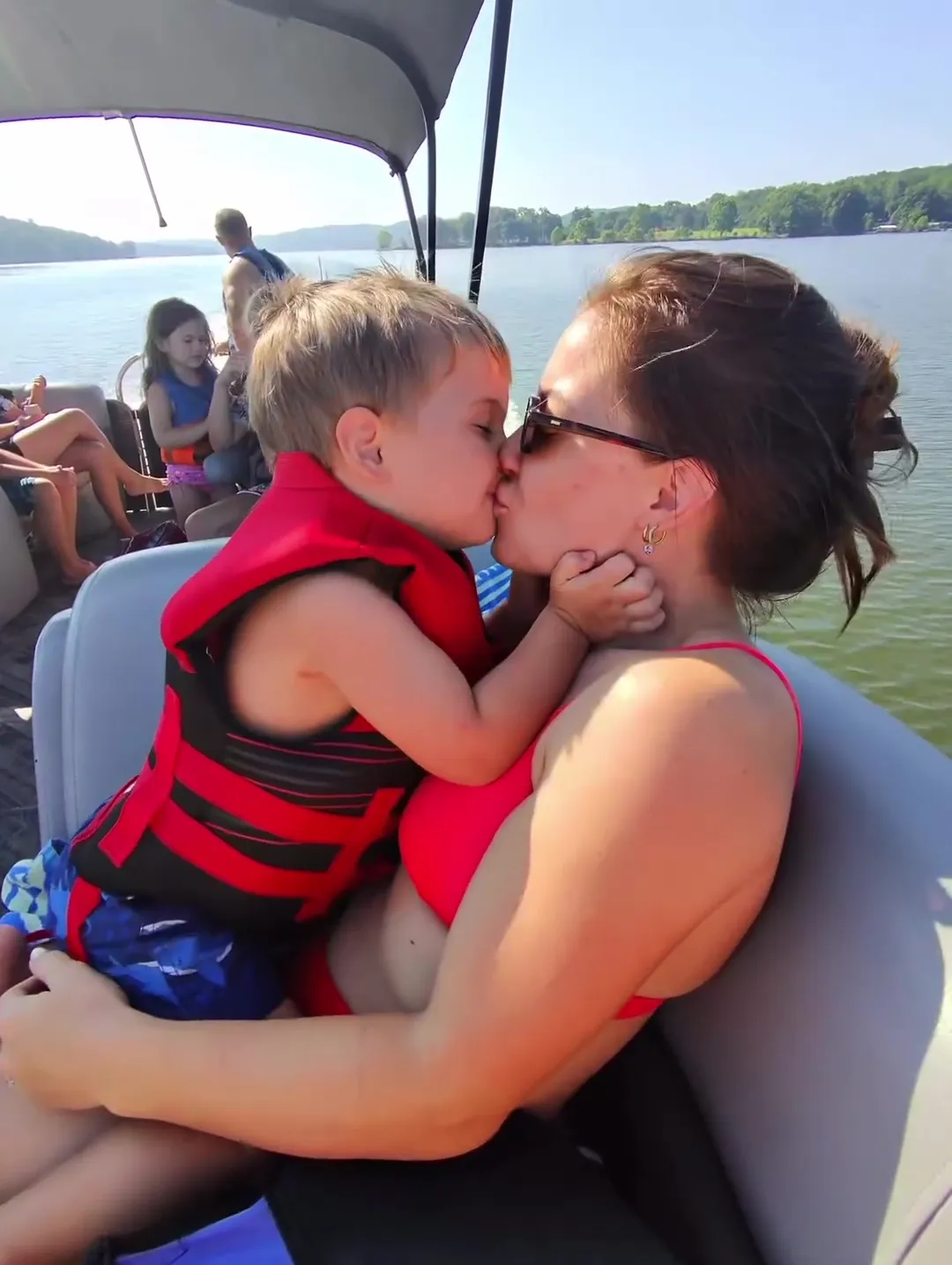 Shawn Johnson kisses her 2-year-old son on the lips while on a boat.