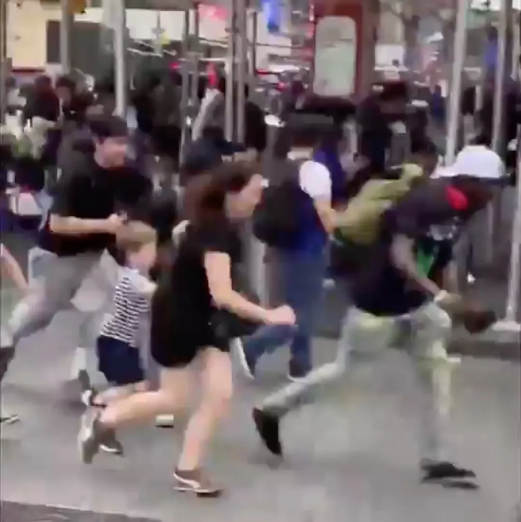 People flee from Times Square after shots were fired.