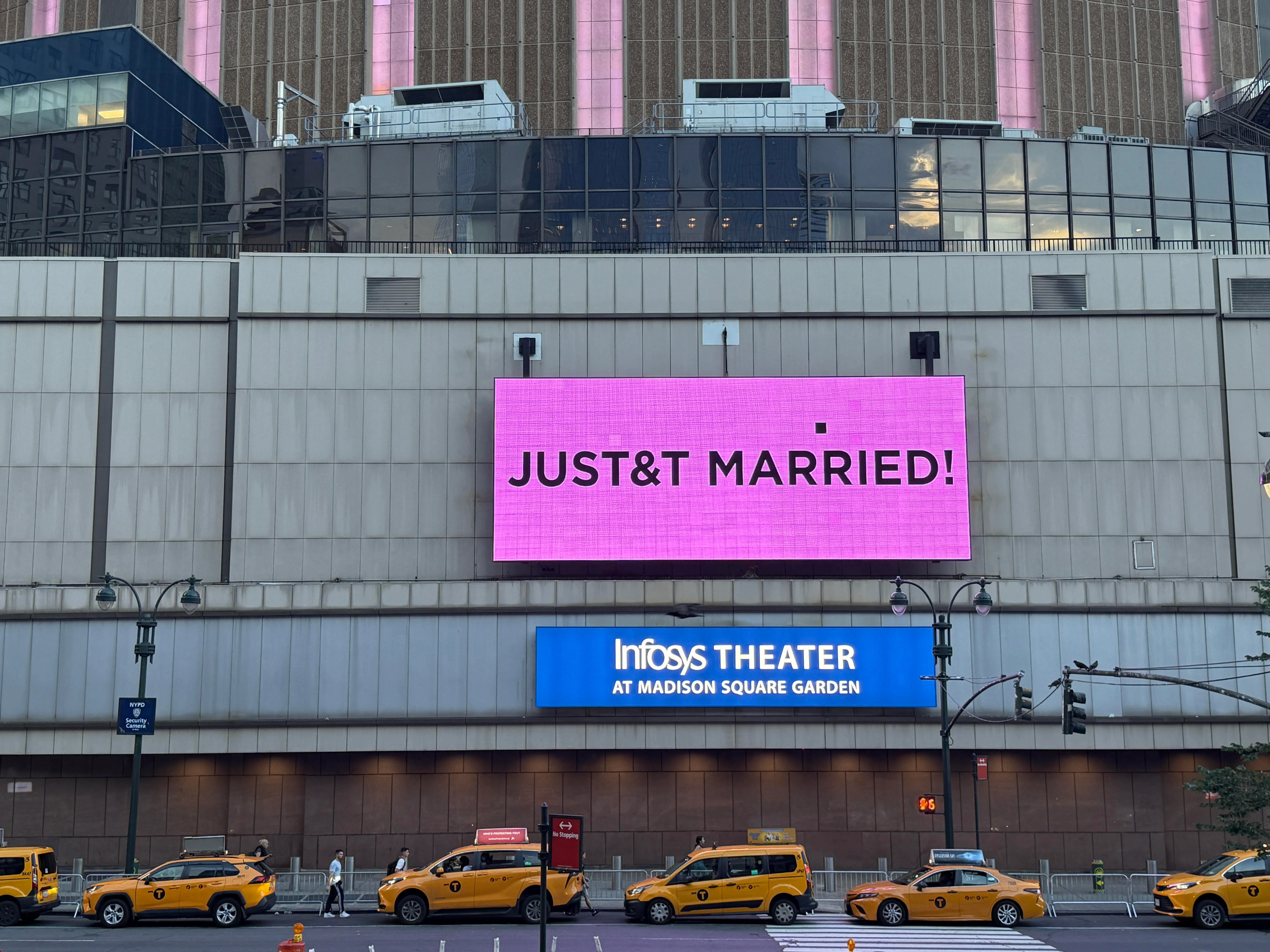A bright pink sign on the side of Madison Square Garden reads "JUST&T MARRIED!"