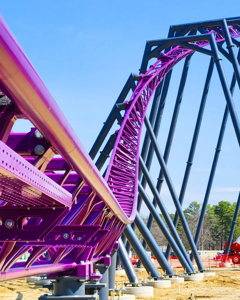 The purple track of the Bakunawa roller coaster under construction.