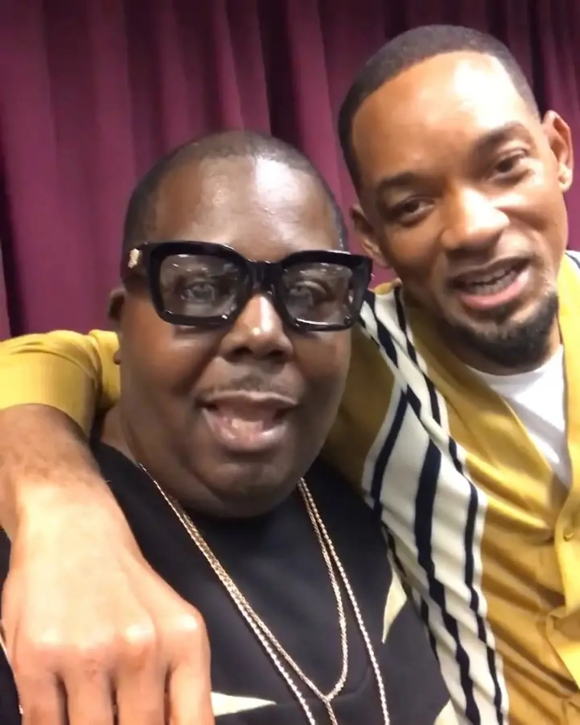 Will Smith smiling with his arm around his former associate.