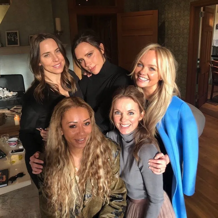 The Spice Girls (Mel B, Victoria Beckham, Geri Halliwell, Emma Bunton, and Mel C) posing together.
