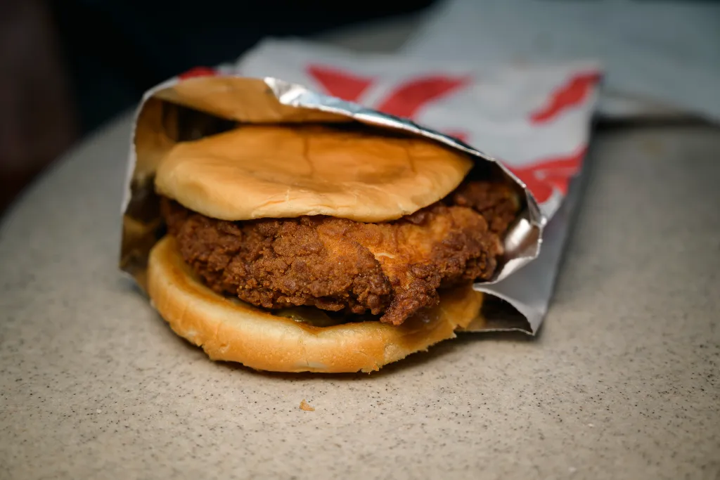 A Chick-fil-A fried chicken sandwich in foil wrapper.